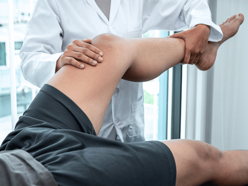 Man receiving physiotherapy treatment on his knee